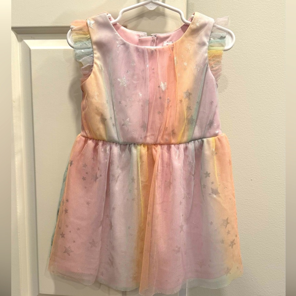Pastel dress with netted outer layer.